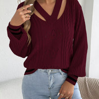 Burgundy cable knit sweater with cutout shoulders and V-neck, ribbed cuffs