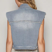 Back view of light wash denim sleeveless vest with raw hem and seam detailing
