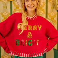 Red sequin Christmas sweater with “MERRY & BRIGHT” lettering and white fringe edge