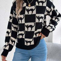 Front view: black and cream ghost checkerboard knit sweater with ribbed collar