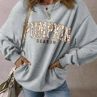 Gray oversized pullover sweatshirt with “PUMPKIN SEASON” graphic print at chest