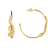 Gold serpent hoop earrings with rhinestone-like accents, shown with hoop shape
