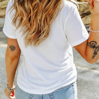 Women's white short-sleeve T-shirt, back view; small tattoo graphic on sleeve