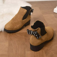 Tan suede ankle boots with round toe, block heel, and jeweled bow at collar