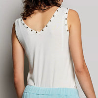 Cream backless tank with studded shoulder trim and V-back neckline