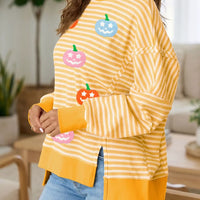 Yellow striped Halloween waffle-knit pullover with pumpkin graphic and side slits