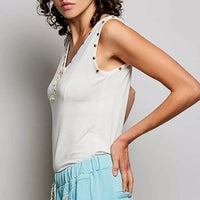 Cream button-front tank with studded neckline trim and ruffle placket