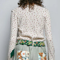 Ivory ribbed knit long sleeve top with tiny floral print, back view