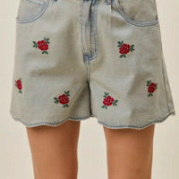 Light-wash denim shorts with rose embroidery and front button waist