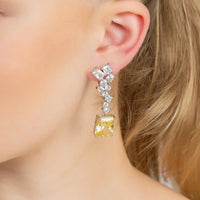 Silver drop earrings on ear: square lemon-yellow topaz with white crystal drop