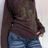 Dark brown long sleeve t-shirt with ornate floral skull graphic on front