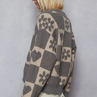 Womenโs heart checkered sweater back view, gray with beige heart and flower motifs.