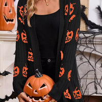 Black open-front knit cardigan with repeating orange pumpkin jack-o'-lantern motifs