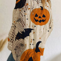 Plus size loose knit cover-up with cream base and orange pumpkin, bat, and moon print.
