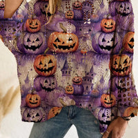 Plus size loose knit cover-up with purple base and repeated orange jack-o'-lantern pumpkin print.
