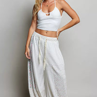 Ivory patchwork knit wide-leg pants with elastic waistband and allover speckled accents