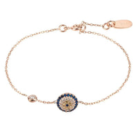 Rose gold evil eye bracelet with blue circular charm on a delicate chain