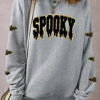 Gray Halloween pullover with sequin 'SPOOKY' front graphic and bat-pattern sleeves