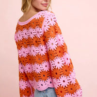 Floral crochet knit top in orange and pink with long sleeves and ribbed scoop neck.