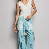 Cream button-front ruffle tank with studded neckline and decorative button placket