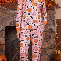 Dusty pink pumpkin-print long-sleeve pajama set with orange-trim pockets and pants cuffs