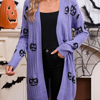 Purple open-front knit cardigan with black jack-o-lantern pattern, draped front