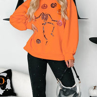 Orange Halloween skeleton pumpkin sweatshirt with long sleeves and front graphic