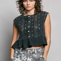 Black lace sleeveless top with round neck, button front, and ruffled peplum hem