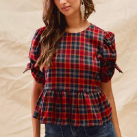 Red plaid peplum top with ribbon-tied short puff sleeves