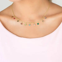 Gold multi-colored gemstone necklace worn on neck, round colored stones on chain