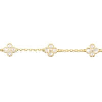 Gold link bracelet featuring three clover-shaped crystal flower charms