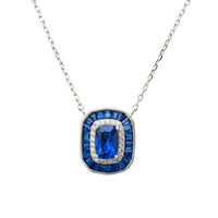 Silver sapphire pendant necklace with square blue stone bezel and halo accents