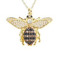 Gold honey bee pendant necklace with crystal-set wings and black enamel body