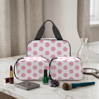 3-piece light pink polka dot makeup bag set with black handles and two zip pouches