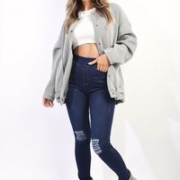 Dark blue high-waisted skinny jeggings with ripped knees and worn, faded areas