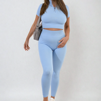 Light blue ribbed half-zip crop top and high-waist leggings set, walking pose