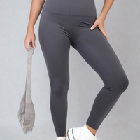Charcoal high-waisted leggings close-up, wide waistband and stretchy fitted legs