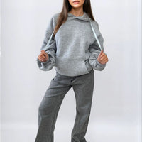 Oversized gray hoodie with ruched sleeves, front pouch pocket, and drawstring hood