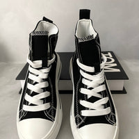 Kids black high-top lace-up trainers with heart accents and white laces