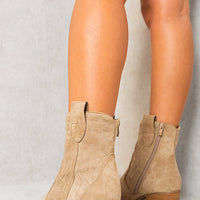 Beige western ankle boots with side zipper and textured embroidery on shaft