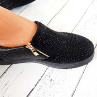Black slip-on trainer with rhinestone-dotted upper and croc-effect panel, gold zip detail.