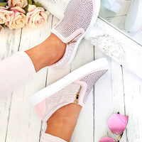Pink slip-on trainers with diamante front and croc-effect side panels, gold zip trim.