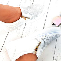 White slip-on trainer with diamante front and gold zip detail.