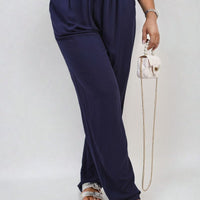 Navy high-waist drawstring pants with side pockets and gathered cuffs