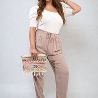 Taupe high-waist drawstring trousers with side pockets and soft tapered fit
