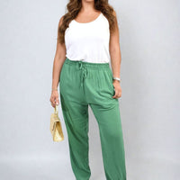 Green high-waist drawstring trousers with side pockets and gathered waist