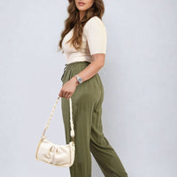Olive green high-waist drawstring pants with side pockets and gathered ankle cuffs