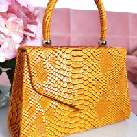Faux Leather Handbag in Lilac with Top Handle and Chain Strap