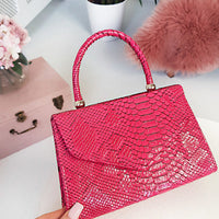 Faux Leather Handbag in Lilac with Top Handle and Chain Strap
