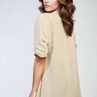 Cream open-front cardigan with rolled short sleeves and relaxed drape